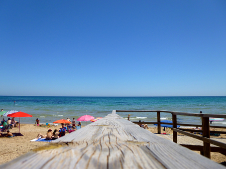 wooden footbridge on the sandy beach in summerの写真素材