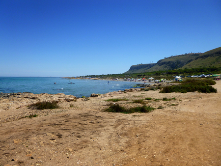 panoramic view of a beach with people enjoying the summerの写真素材