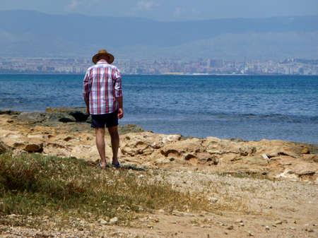 man walking by the seashore in summerの写真素材