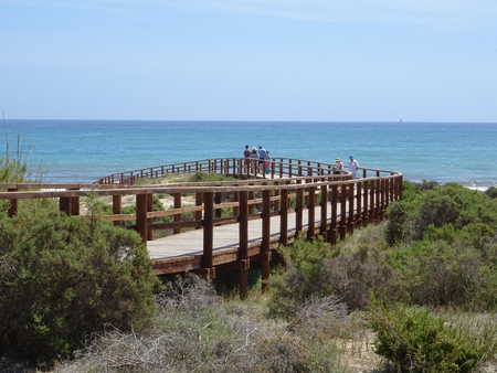 Wooden walkways leading directly to a beautiful beach of fine sandの写真素材