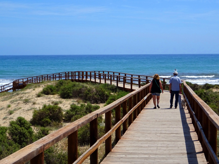 Wooden walkways leading directly to a beautiful beach of fine sandの写真素材