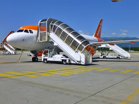 Easyjet Aircraft on the runway of Geneva Airport, Switzerland. Passenger traffic in summer.のeditorial素材