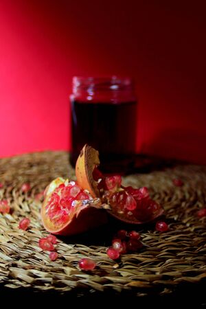 Pomegranate still life and glass jar with pomegranate juice. Super fruit with excellent propertiesの写真素材