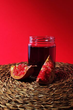 Pomegranate still life and glass jar with pomegranate juice. Super fruit with excellent propertiesの写真素材