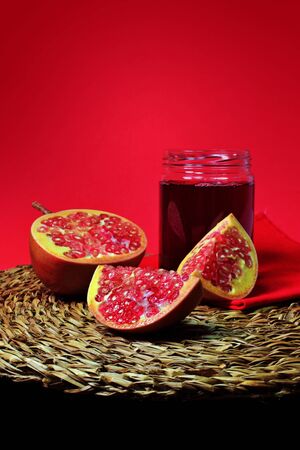 Pomegranate still life and glass jar with pomegranate juice. Super fruit with excellent propertiesの写真素材