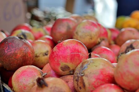 Bunch of pomegranates at an outdoor market stall. Pomegranate of the Mollar variety of Elche, Alicante, Spain.の写真素材