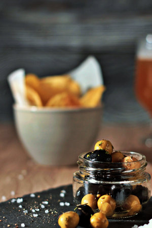 jar of black and green olives, lined with aromatic herbs. Still life of appetizers, snacks and pickles. Intense flavorsの写真素材