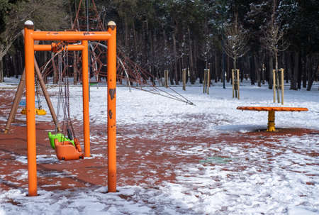 Beautiful children playground in the snow in winterの写真素材