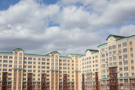 Gray clouds over city housesの写真素材