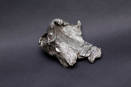 Tektite Meteorite Sikhote Alin isolated on gray backgroundの写真素材