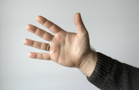 Male palm on a gray background