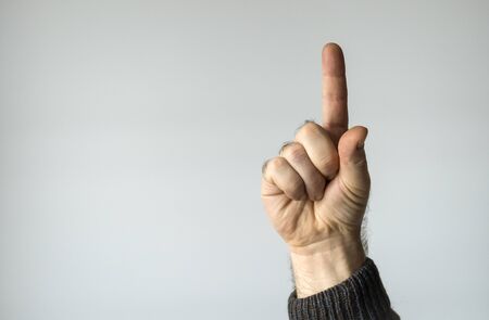 Male finger on gray pointing up