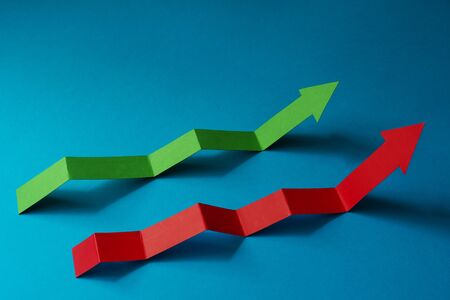 Red and green financial graph on a blue backgroundの写真素材