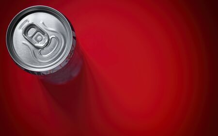Aluminum beer can top view on red background, copy space for text.