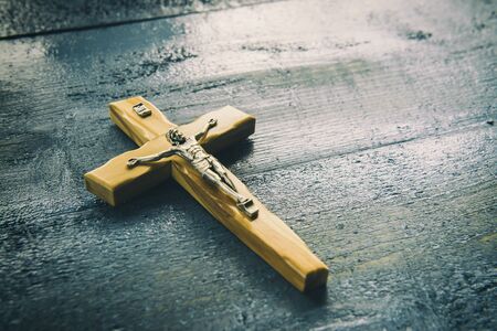 Wooden catholic cross on a blue background