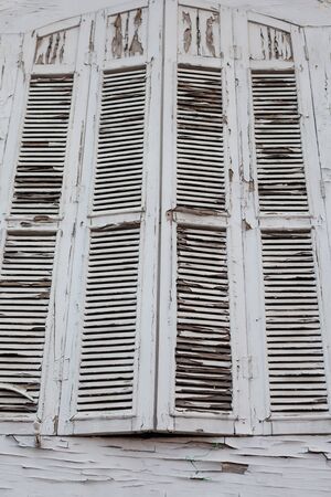 White window of abandoned building with cracks and dirtyの写真素材