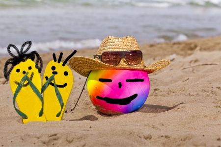 funny summer with thong sandals and ball with face の写真素材