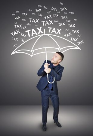 businessman who is protected from taxesの写真素材