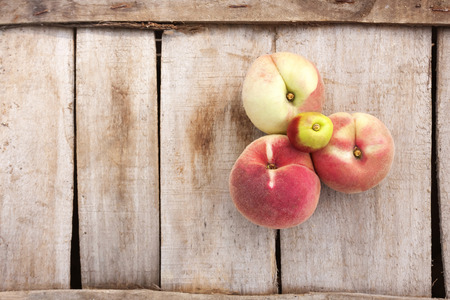 white peach and on a wood backgronudの写真素材