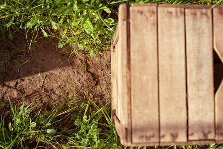 Wooden crate resting on the soil of countrysideの写真素材