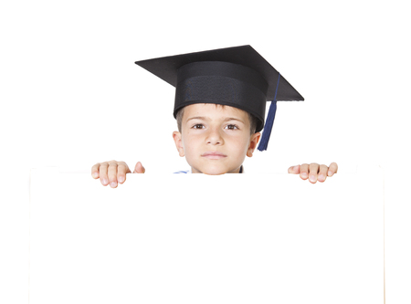 Caucasian boy with a university cap leaning on copyspaceの写真素材