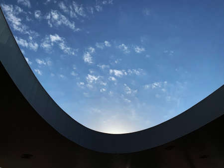 The sky behind oval building rooftopの写真素材