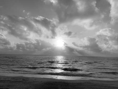 fading beach sunset at summer days, black and white backgroundの写真素材