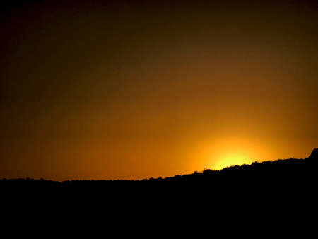Background of yellow sunset via the mountains black and yellowの写真素材