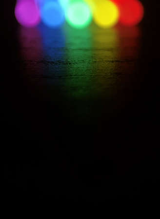 Light reflating on dark wood , light created from  glow sticks , partly Prism color orderの写真素材