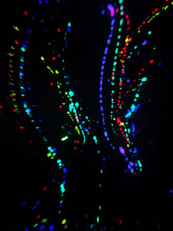 Background of messy real neon colors liquid spilled on a wall