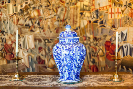 two candles and antique vase on the tableのeditorial素材