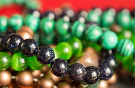 Multi-colored beads on a red の写真素材