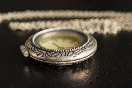 Watch from metal with a chain on a black の写真素材