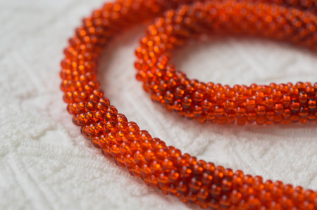 Necklace fragment from bright orange beads close upの写真素材