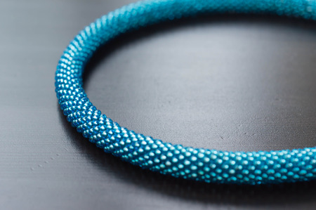 Fragment of a turquoise necklace on a wooden background close upの写真素材
