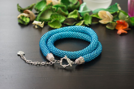 Necklace from beads of turquoise color on a wooden backgroundの写真素材