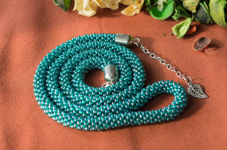 Green-blue necklace from beads with a chainの写真素材