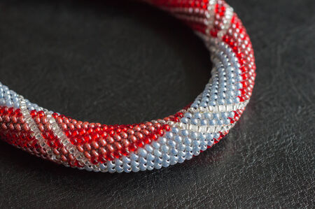 Necklace fragment from small beads against a dark backgroundの写真素材