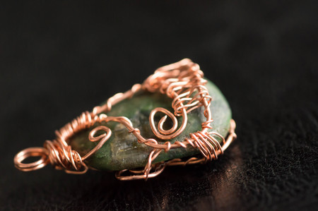 Wire wrapped pendant against a dark background close upの写真素材