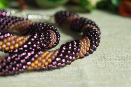 Fragment of a two-color necklace from beads close up