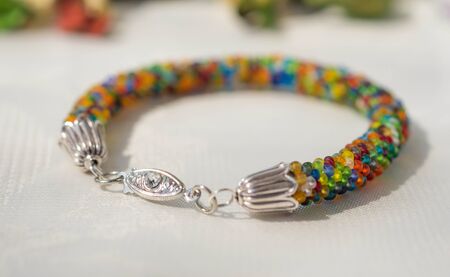 Knitted bracelet from small multi-colored beads close upの写真素材