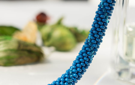 Fragment of a knitted necklace from blue beads close upの写真素材