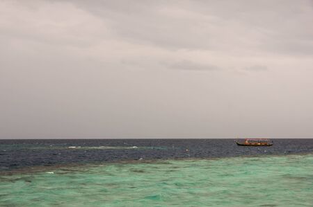 Indian Ocean and the boat in cloudy weatherの写真素材