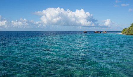 Seascape with boats near the tropical islandの写真素材