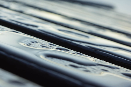 Drops of water on the wooden boards after rainの写真素材