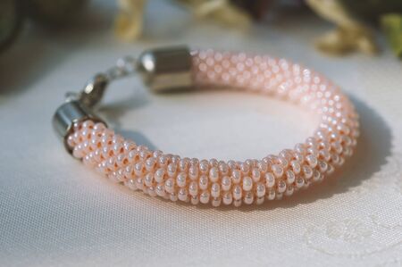 Knitted bracelet from pink beads close upの写真素材