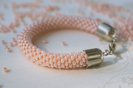 Knitted bracelet from pink beads close upの写真素材