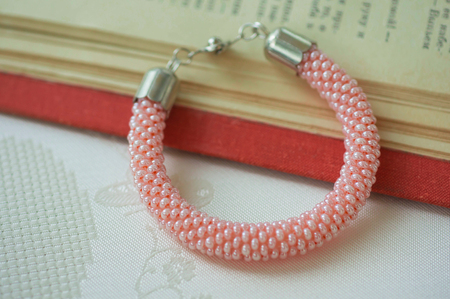 Knitted bracelet from pink beads close upの写真素材