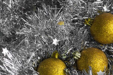 Christmas decorations on a background of shiny tinselの写真素材