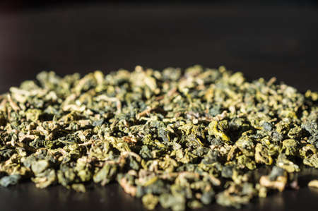 Background of green tea leaves lit by the sunの写真素材